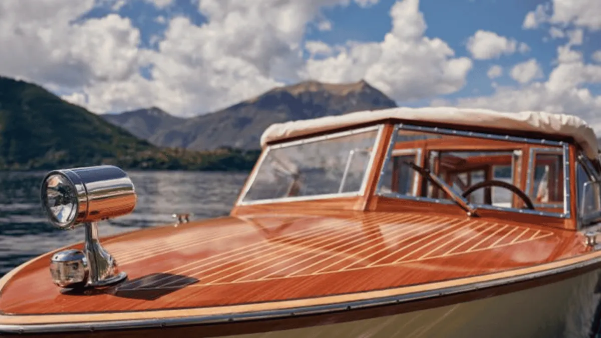Venetian taxi boat cruising at dusk off Varenna on Lake Como