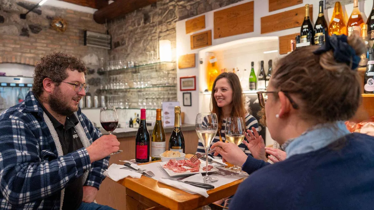 Guided food tour group tasting local dishes in Como old town on Lake Como